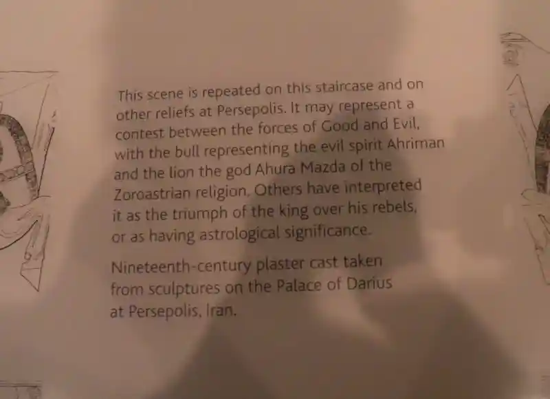 Lion biting the backside of a bull relif